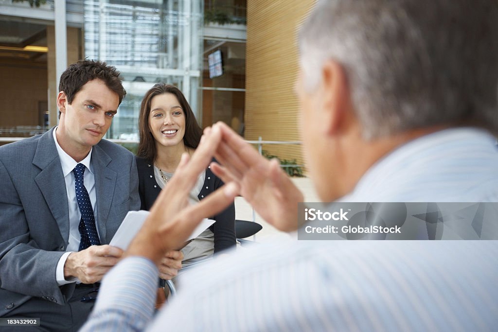 Discussing business strategy Senior business man in discussion with his team 40-49 Years Stock Photo