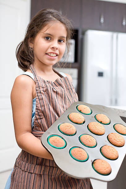 istock Little Girl Baking Cup Cakes 183432917