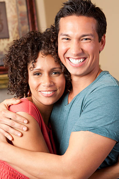istock Mixed race couple holding each other 183433163