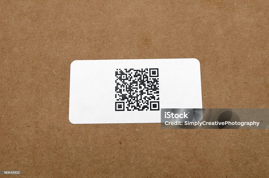 QR Code on Shipping Label New technology barcode called Quick Response Code printed on a shipping label on a cardboard background. Related Images: Abstract Stock Photo