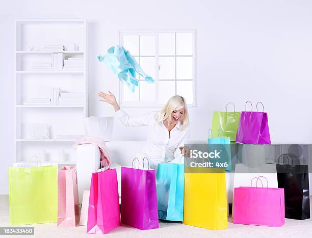 Mujer En La Sala De Estar Que Se Presenta Rodeado De Bolsas De Regalos Foto de stock y más banco de imágenes de Bolsa de la compra