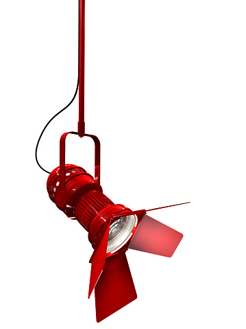 Stage light with red painted housing isolated on white. 3D render.