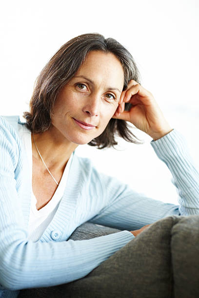istock Pretty mature lady relaxing on couch 183433809