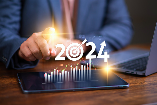 Business growing in 2024, Businessman showing word 2024 marketing monitor and business planing in new year concept. marketing financial and research analysis, business planning and strategy concept.