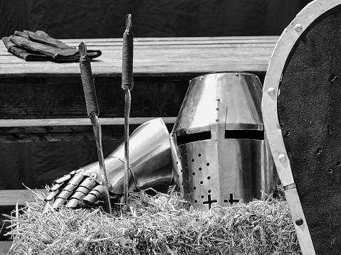 Medieval suit of armor and a  steel helmet in an outdoor still-life