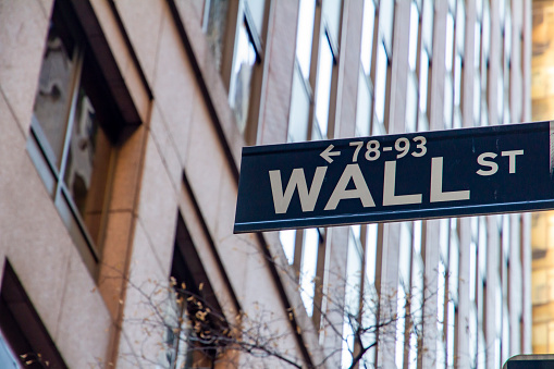 Wall street sign with financial building as background