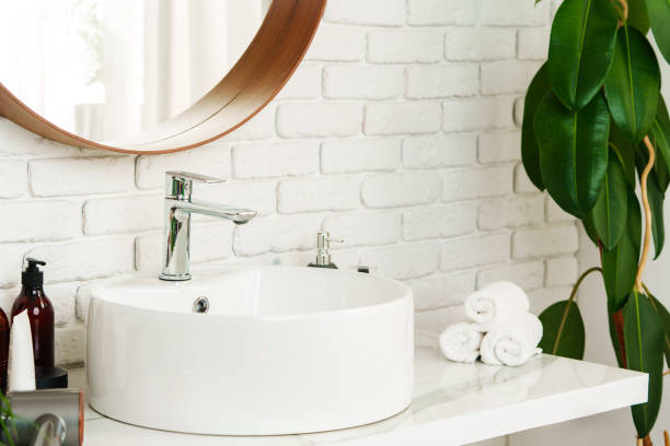 istock Bathroom interior with circle shaped mirror in wooden frame and white sink 1834396778
