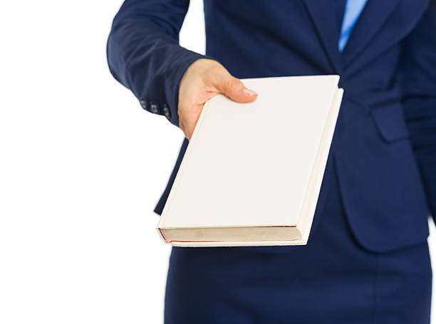 istock Closeup on business woman giving book 183441444