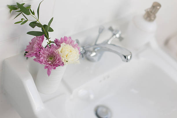 istock Close-up white bathroom sink with flowers 183442820