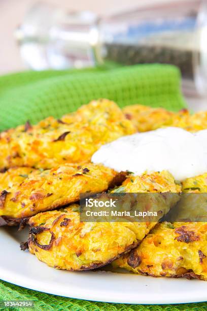 Zucchini Pancakes With Carrots And Sour Cream On Green Towel Stock Photo - Download Image Now