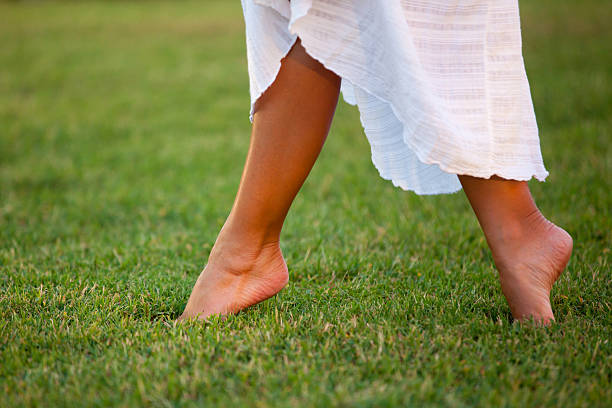 istock Girl is walking on green grass 183443491