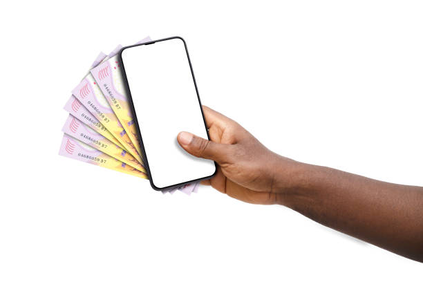 istock Black hand holding mobile phone with blank screen and Central African CFA franc notes 1834440558