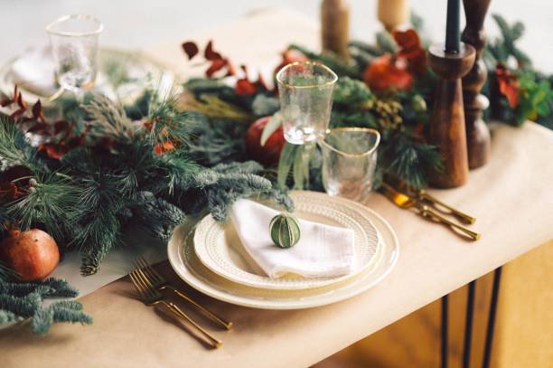 istock Festive and elegant Christmas dinner setting with ornate golden-plated silverware 1834451571