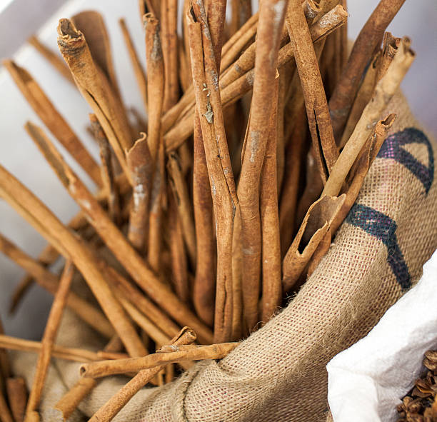 istock Cinnamon sticks and meal close up on wooden table 183445225