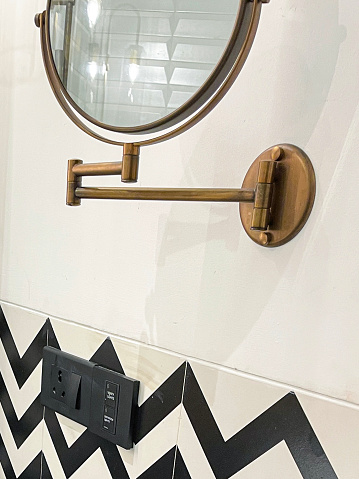 Stock photo showing close-up view of a luxury hotel bathroom with black and white zig-zag patterned wall tiles.