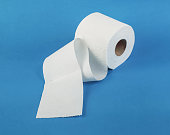White toilet paper rolls on the blue background. Hygiene concept
