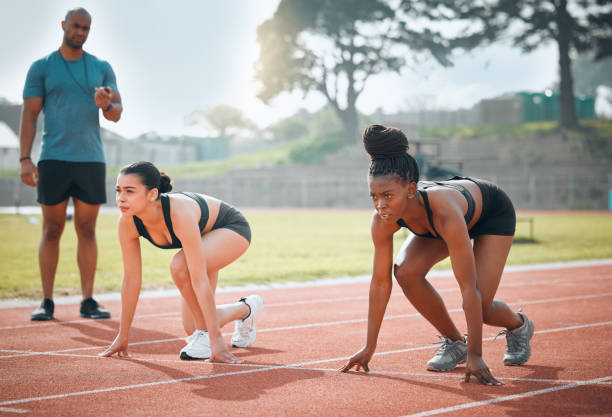 istock Women, runner and start track or coach timer for speed test, training for marathon competition. Female people, athletes or teacher on field in summer sport challenge or fast cardio, action in outdoor 1834493984