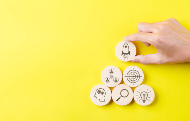 istock Startup business creation concept. Hand holding wooden block with rocket icon and technology business icon. Business goal management, new project to wealth, Company strategy target, Digital marketing, 1834500972
