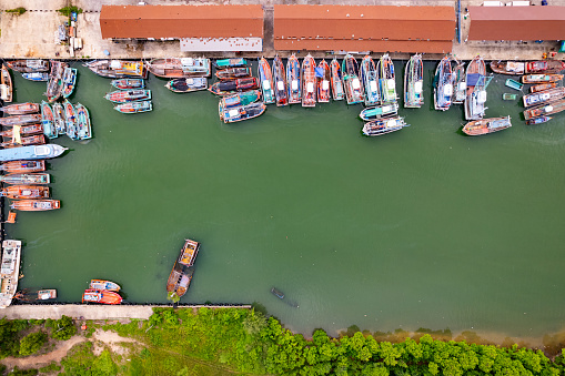 High angle view fisherman boats at the jetty located in Phuket Thailand, aerial view drone top down view,Siray fishing port Phuket Thailand