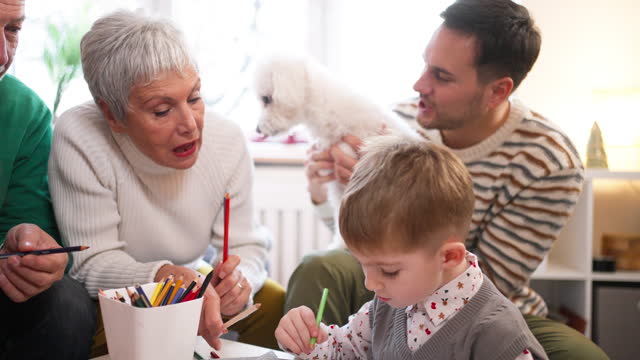 Multi-generational family, coloring the coloring book, during Christmas celebration
