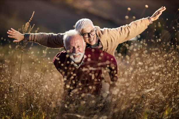 istock Happy senior couple having fun in autumn day. 1834545946
