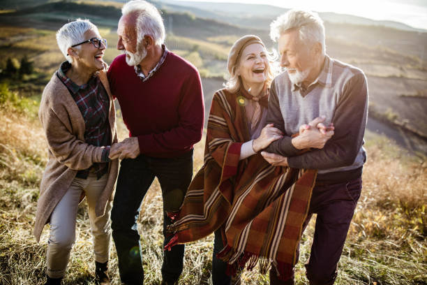 istock Happy senior couples having fun while moving up the hill in autumn day. 1834547578