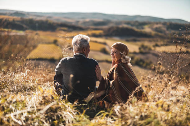 istock Rear view of relaxed senior couple talking on a hill. 1834551210