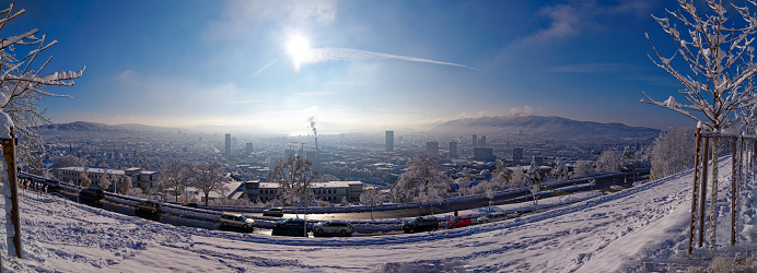 Aerial wide angle view of City of Zürich with skyline and snow landscape on a sunny autumn day. Photo taken December 3rd, 2023, Zurich, Switzerland.