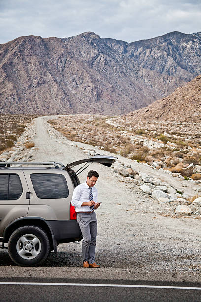 istock Man stuck in desert with car broken down 183458754