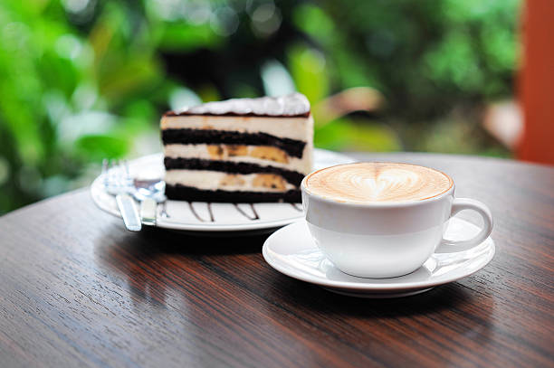 istock Cup of capuchino coffee with Chocolate Banana Cake. 183459206