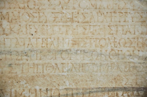 A tablet with an ancient text. A stone slab.