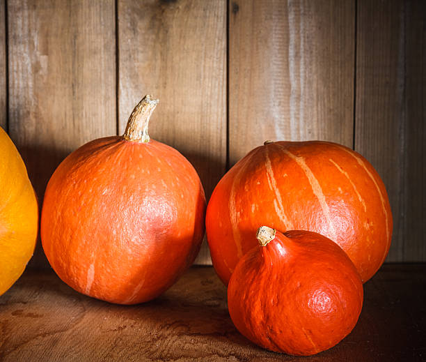 istock Pumpkins on grunge wooden backdrop background 183461815