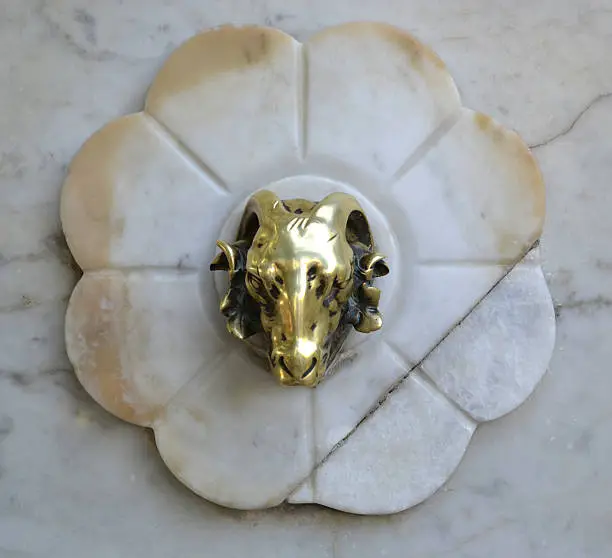 Photo of marble fountain in the shape of ram's head