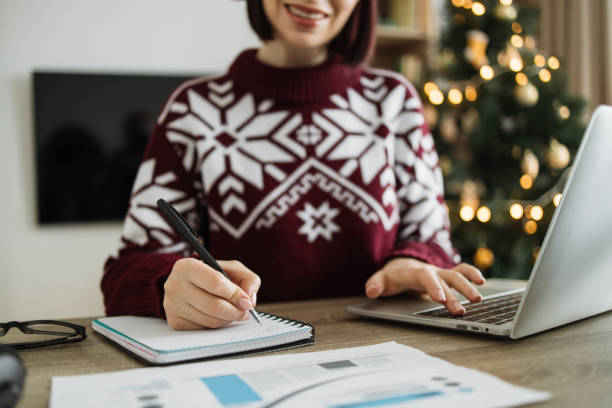 istock Cropped view pf woman hand with pen in Santa hat making notes on paper document 1834627833