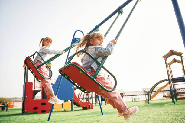 istock Enjoying swing ride. Kids are having fun on the playground 1834630074