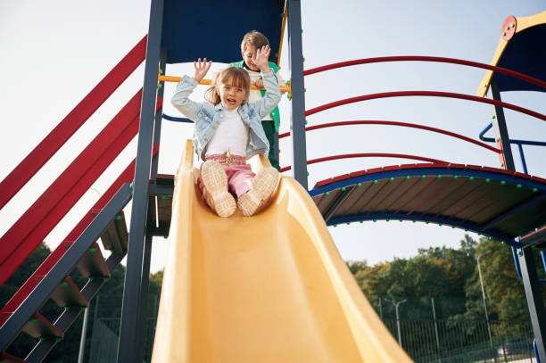 istock Beautiful sunlight. Kids are having fun on the playground 1834632836