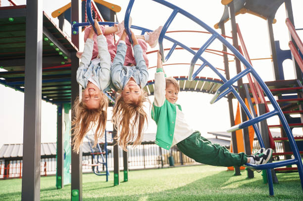 istock Hanging upside down. Kids are having fun on the playground 1834633349