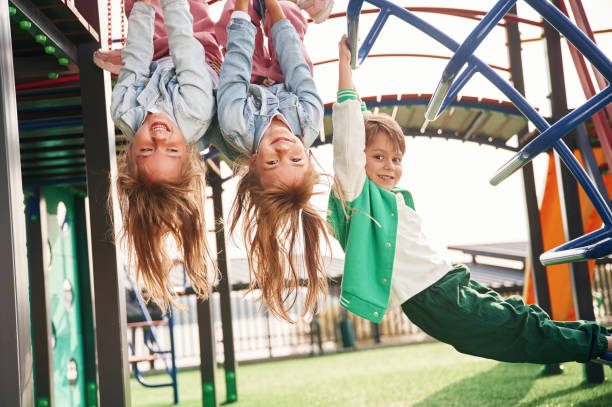 istock Beautiful sunlight. Kids are having fun on the playground 1834633351