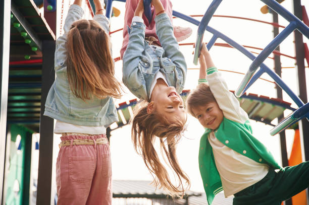 istock Hanging upside down. Kids are having fun on the playground 1834633372