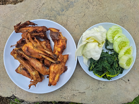 Grilled Chicken Wings, Chicken Legs, Chicken Drumstick With Cucumber, Cabbage And Boiled Papaya Leaves. Food Menu