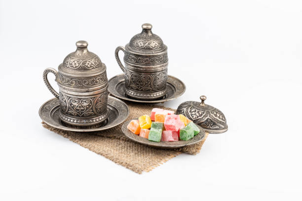 istock Turkish Coffee with Turkish Delight on authentic metal plate, isolated on white background 1834637815