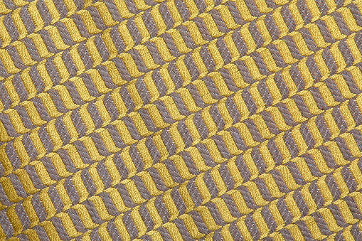 fabric in golden color with geometric patterns. mustard knitted texture, background knitted mustard color