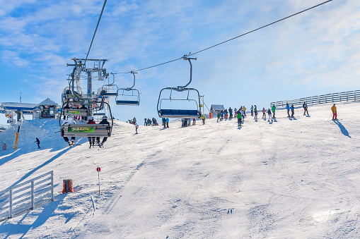 Kopaonik, Serbia - January 22, 2016: Panorama of serbian ski resort, skiers on the chair lift and slope view