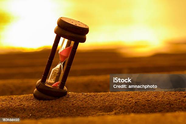 Hourglass On The Sand Stock Photo - Download Image Now - Hourglass, Urgency, Abstract