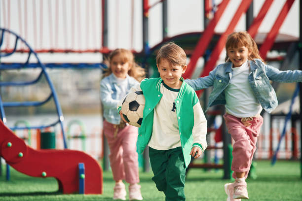 istock On the playground. Kids are having fun together 1834664987