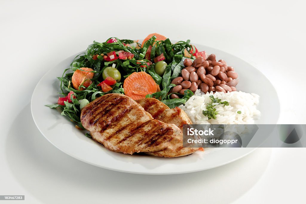 Typical dish of Brazil, rice and beans This is the most common dish in Brazil, rice, beans, steak and tomato salad with lettuce. Plate Stock Photo