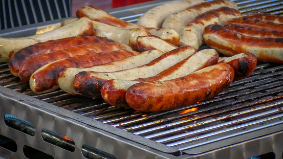 white sausages, close-up, on a barbecue