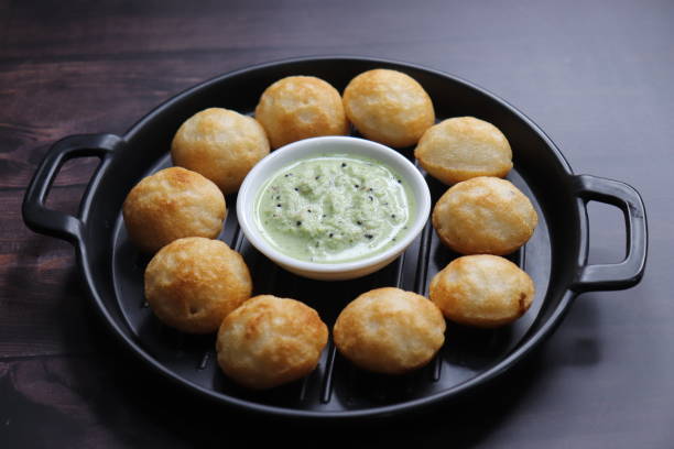 istock Paniyaram are savory balls made using fermented rice and urad dal batter along with tempered onion and spices. Also known as Paddu, Ponganalu, Kuli, bugga, and appe. served with coconut chutney 1834674542