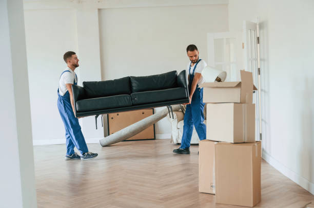 istock Holding heavy sofa. Two moving service employees in a room 1834676963
