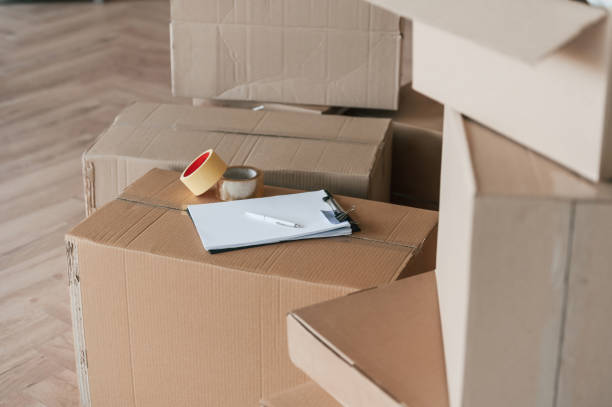 istock Boxes with scotch tape and notepad. Conception of moving to new house 1834690052